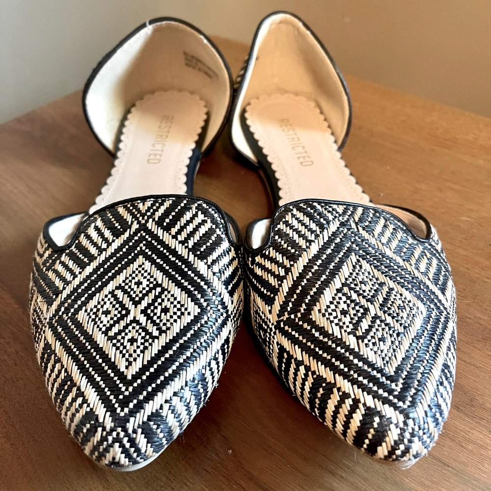 Restricted black and cream pointed flats